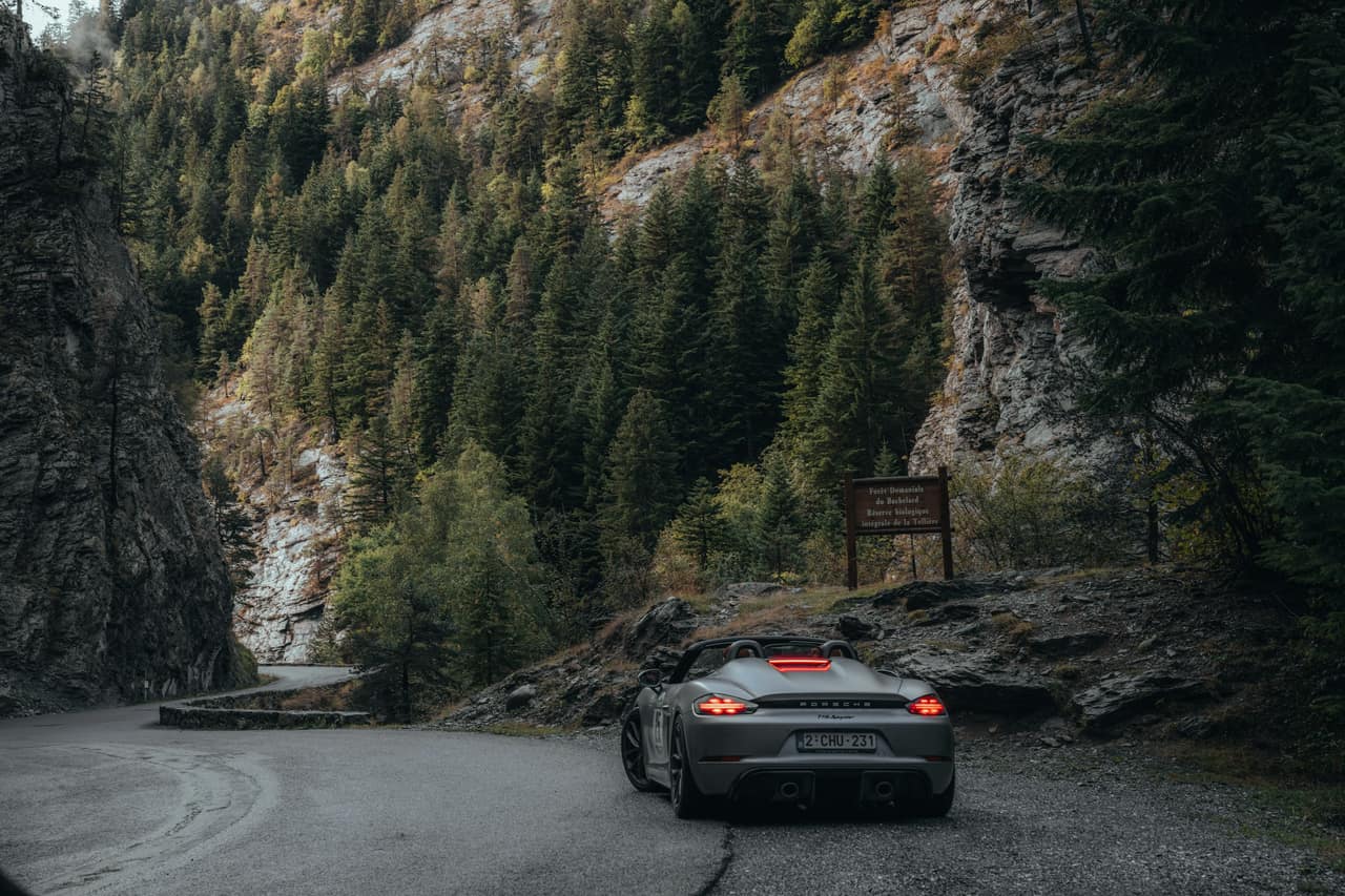A sports car crossing a European mountain landscape